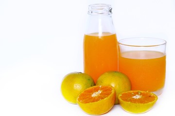 The Orange juice bottle with orange juice glass and oranges,half fresh oranges isolated on white background