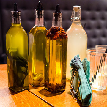 Olive oils and lemoniade on wooden tabale