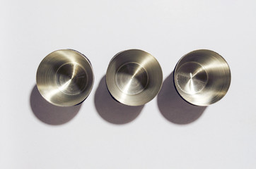 metal cups on white background