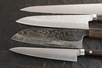 Set of new and used knives on cutting board