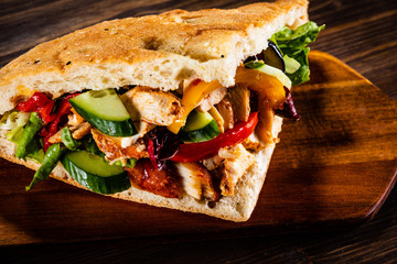 Kebab - grilled meat and vegetables on wooden background