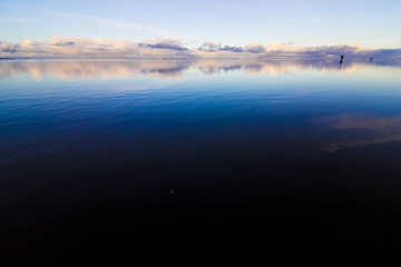 Reflection of the clearing skies above Red Wharf Bay, Anglesey, North Wales
