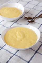 Side view, homemade vanilla custard pudding on cloth. Closeup.