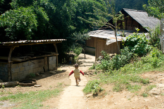 Vietnamese child running in the Village, Sa Pa, Vietnam