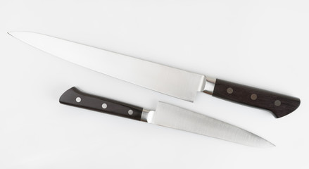 Two kitchen knives on light gray background