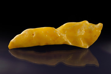 A unique piece of solar amber on a black background.