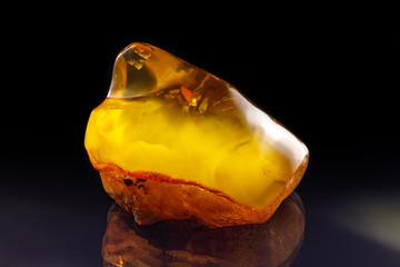 A unique piece of solar amber on a black background.