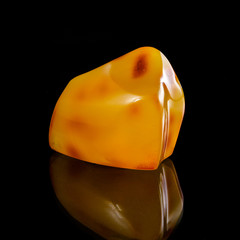 A unique piece of solar amber on a black background.