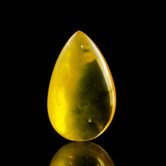 A unique piece of solar amber on a black background.