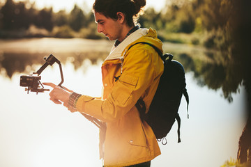 Man operating a camera fixed on a gimbal