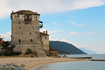 Fototapeta na wymiar Old tower at the beach in Ouranoupoli, Athos peninsula, Chalkidiki, Greece