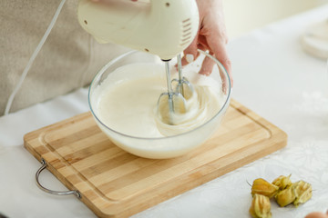 female preparing thick cream for baking, close up crropped photo