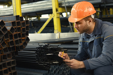 Young handsome industrial worker with a clipboard