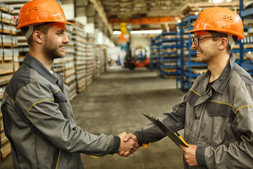 Engineer shaking hands at the industrial factory