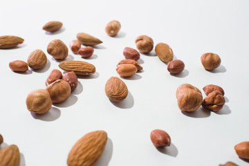Pattern of nuts mix with copy space. Various nuts isolated on white.