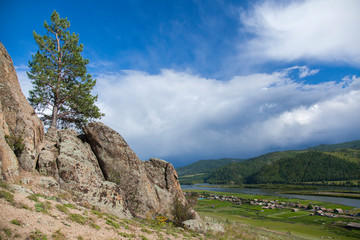 Summer landscape. Zabaykalsky krai, a village Zhindo, Far East, Russia. Chikoi river on the border of Russia and Mongolia. Siberia. Hills. Siberian river. Summer in Siberia. village on river