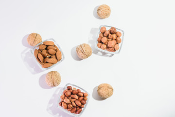 Peanuts, hazelnuts, almonds and walnuts on a white background