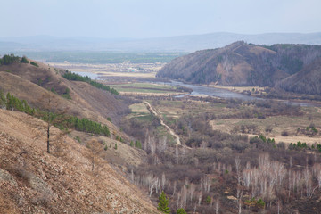Spring landscape. Zabaykalsky krai, a village Zhindo, Far East, Russia. Chikoi river on the border of Russia and Mongolia. Siberia. Sopkas. Hills. Siberian river. May in Siberia