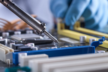 The scientist holds the computer part