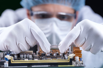 The scientist holds the computer part