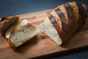 slice of fresh tasty homemade baked bread on wooden board