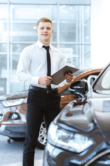 Professional salesman at the car dealership