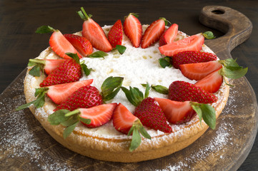 cheesecake with strawberries on a wooden Board.