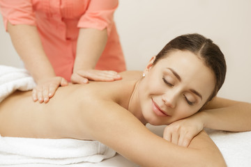 Beautiful female client enjoying full body massage at the spa salon