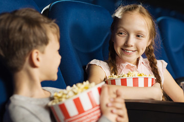 Obraz na płótnie Canvas Group of happy kids enjoying a movie at the cinema