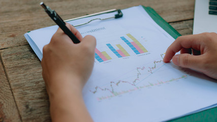 Young architects are analyzing the stock chart in the company.