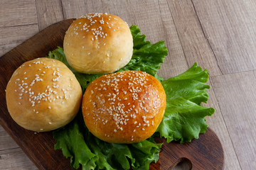 burger rolls on a light wooden background