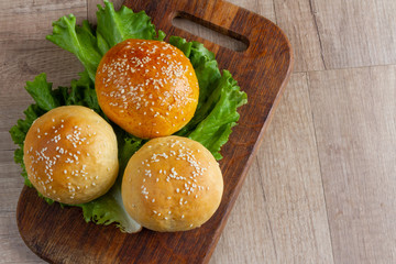 burger rolls on a light wooden background