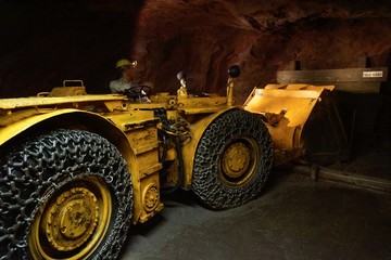 bulldozer working in tunnel pushing gravel outside