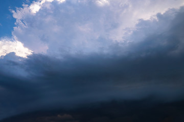 Scary epic sky with menacing clouds. Hurricane wind with a thunderstorm. Stock background, photo