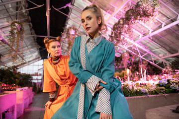Beautiful blonde woman being in the greenhouse
