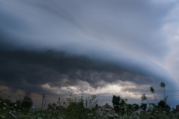 Scary epic sky with menacing clouds. Hurricane wind with a thunderstorm. Stock background, photo