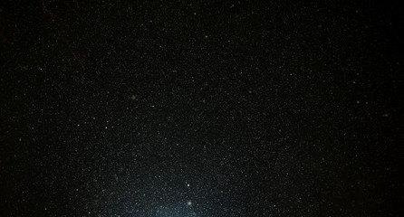 Snow flies in the sky at night as a background