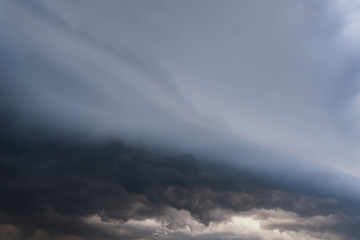 Scary epic sky with menacing clouds. Hurricane wind with a thunderstorm. Stock background, photo