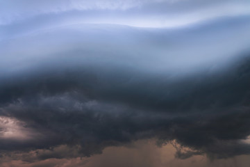 Naklejka na ściany i meble Scary epic sky with menacing clouds. Hurricane wind with a thunderstorm. Stock background, photo