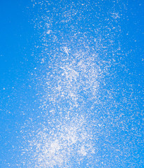 Naklejka na ściany i meble Splashes of water against the blue sky
