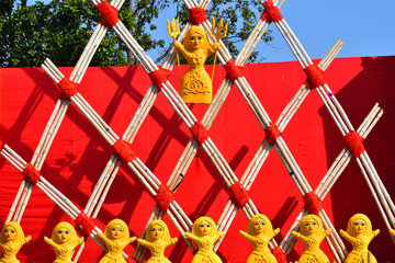 clay dolls on some Parallelograms structure of wooden sticks tied with red ropes and a red...