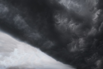 Scary epic sky with menacing clouds. Hurricane wind with a thunderstorm. Stock background, photo