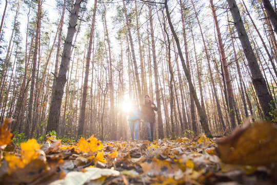 Adventures, Tourism And Nature Concept - Low-angle Shot Of Walking Hike Couple In A Distance