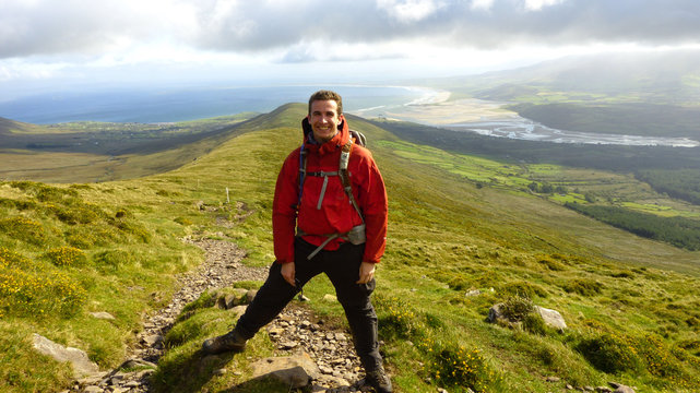 Hiking in the Dingle Peninsula with green landscapes, Ireland.