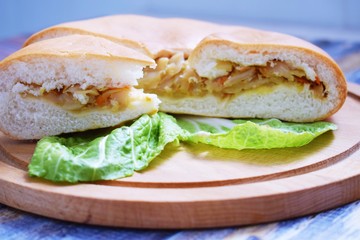 Delicious cabbage pie on wooden background.Homemade cake.