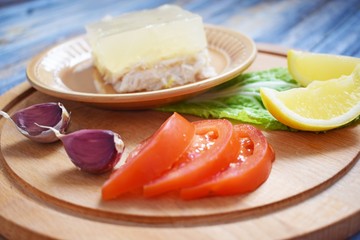 Aspic of chicken and vegetables on wooden background.