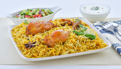 Chicken Biryani, a yummy & fluffy rice dish with spicy savory chicken pieces with salad.