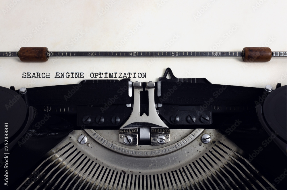 Fototapete old retro vintage black typewriter with close-up typing text search engine optimization as heading o