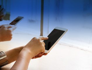 Human hand use finger pointing on mobile phone screen,graduated filters,blurry light around