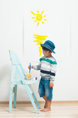 Happy child paints with paint.